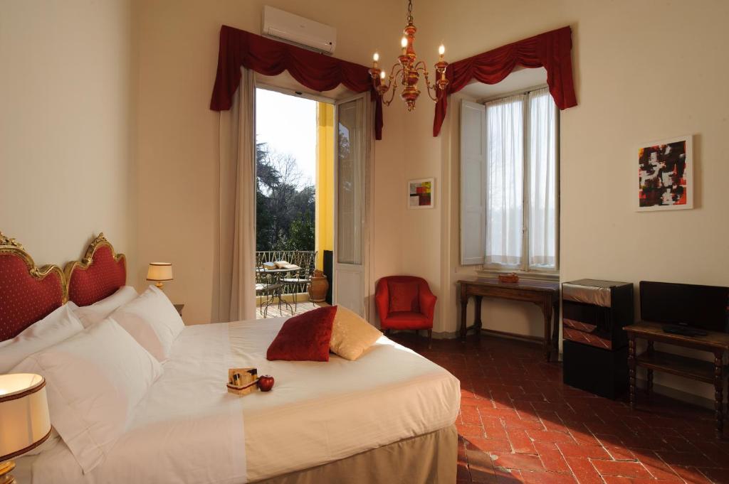 a hotel room with a large bed and a large window at Hotel Annalena in Florence