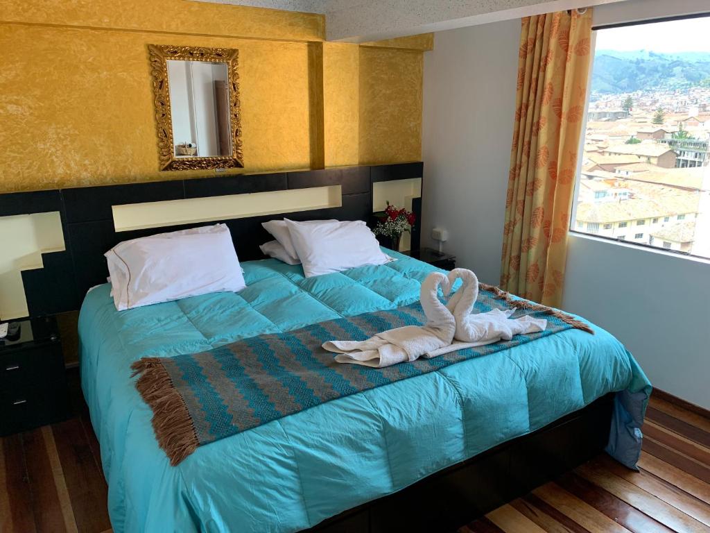 Uma cama ou camas num quarto em Hostal Qolqampata