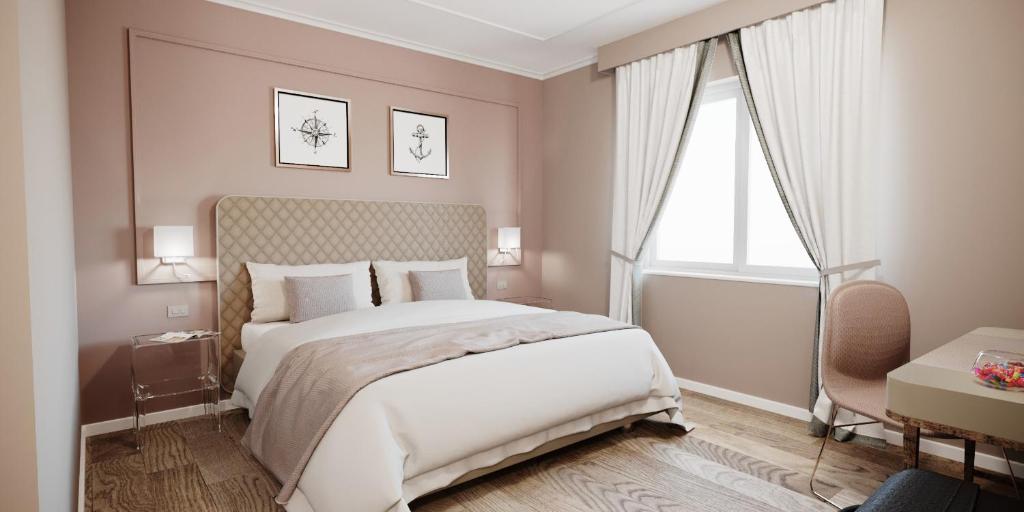 a bedroom with a large white bed and a window at Mercury Rooms in Cagliari