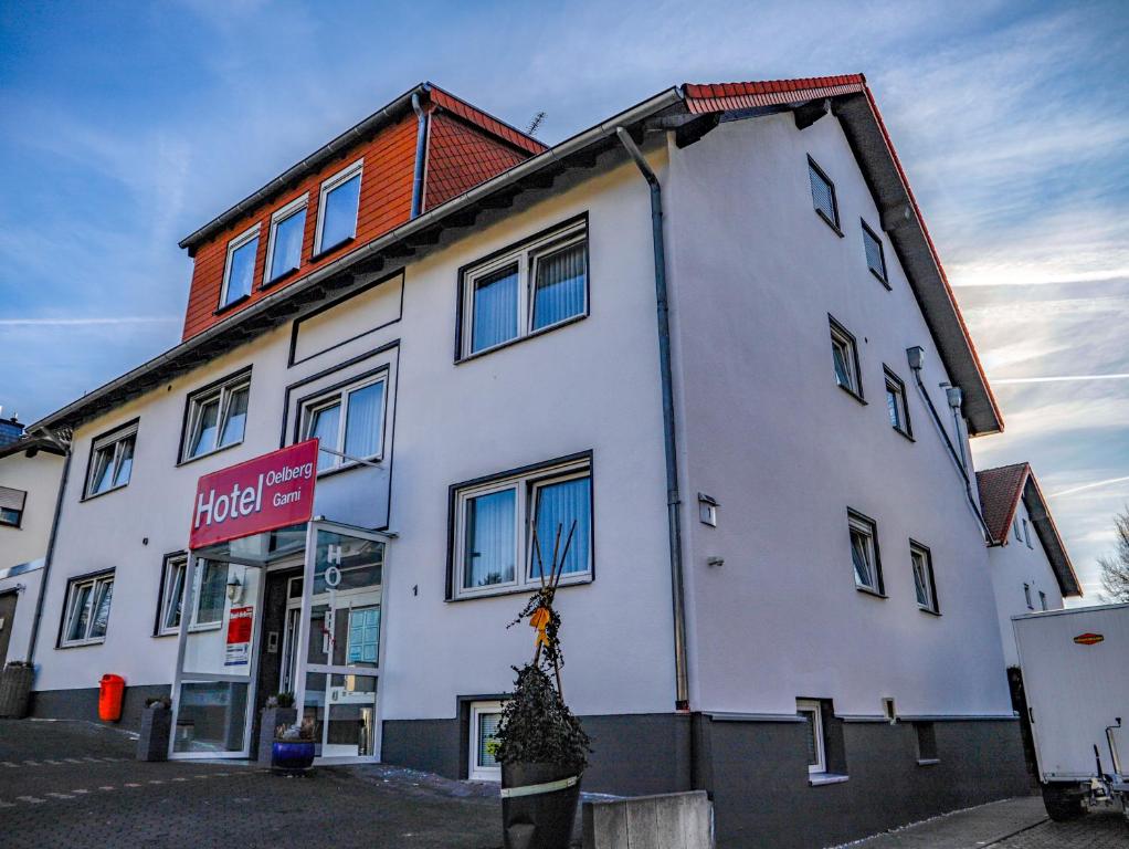 a white building with a christmas tree in front of it at Hotel Oelberg budget - BONN SÜD Königswinter in Königswinter