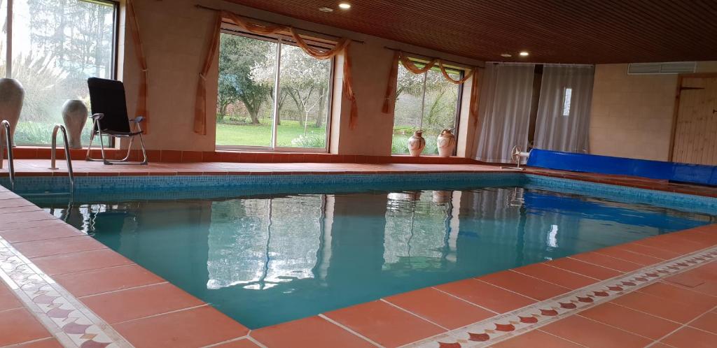 a swimming pool with blue water in a house at Lower grange park in Chacombe