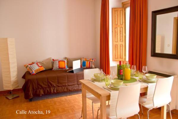 a living room with a table and a couch at Apartamentos Madrid in Madrid