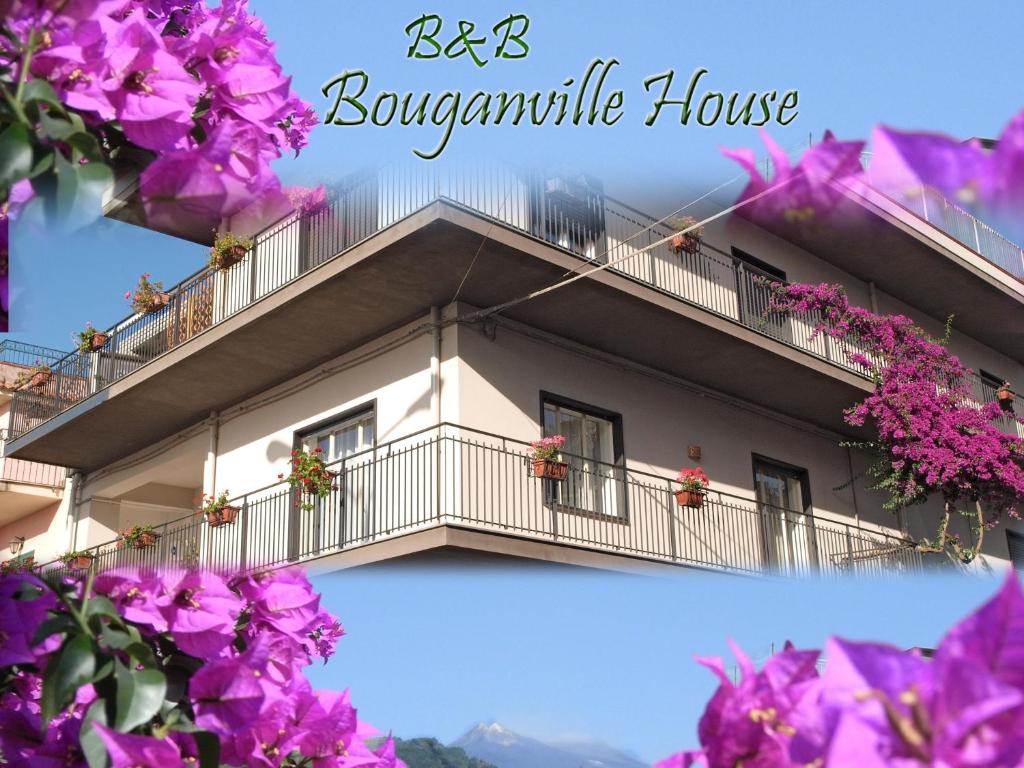 a building with flowers in front of it at Bouganville House in Zafferana Etnea