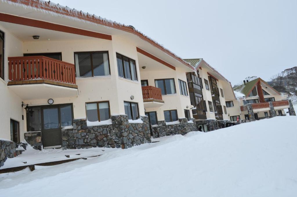 a building with snow in front of it at Salzburg Apartments in Perisher Valley
