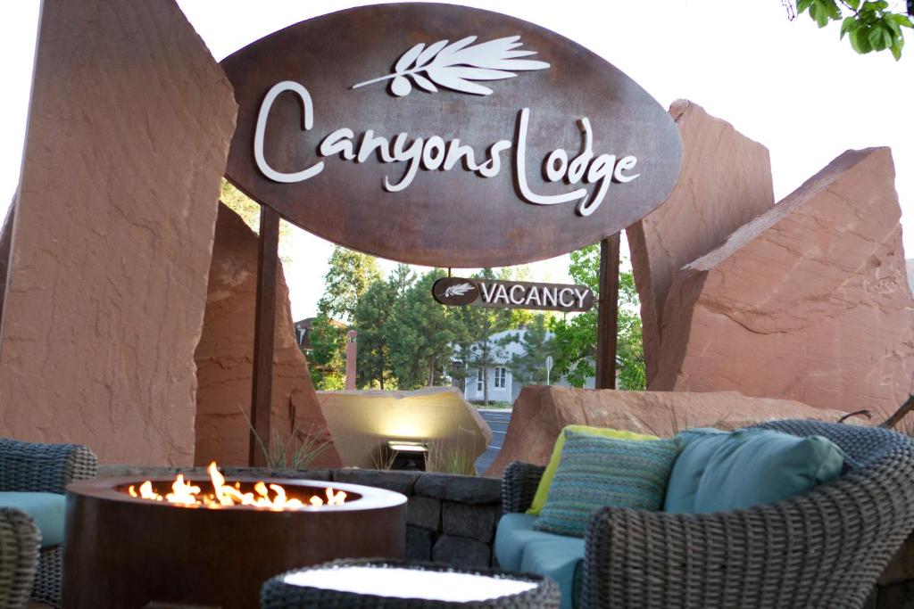 a sign for an outdoor patio with chairs and a fire pit at Canyons Lodge- A Canyons Collection Property in Kanab