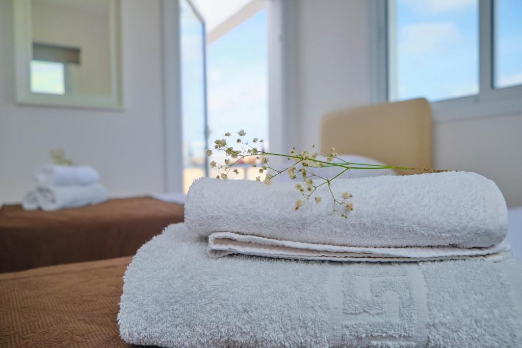 a pile of towels sitting on top of a table at FIG TREE GIANNIS in Protaras