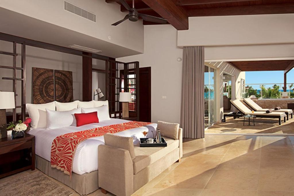 a bedroom with a large bed and a patio at Dreams Dominicus La Romana Resort & Spa in Bayahibe