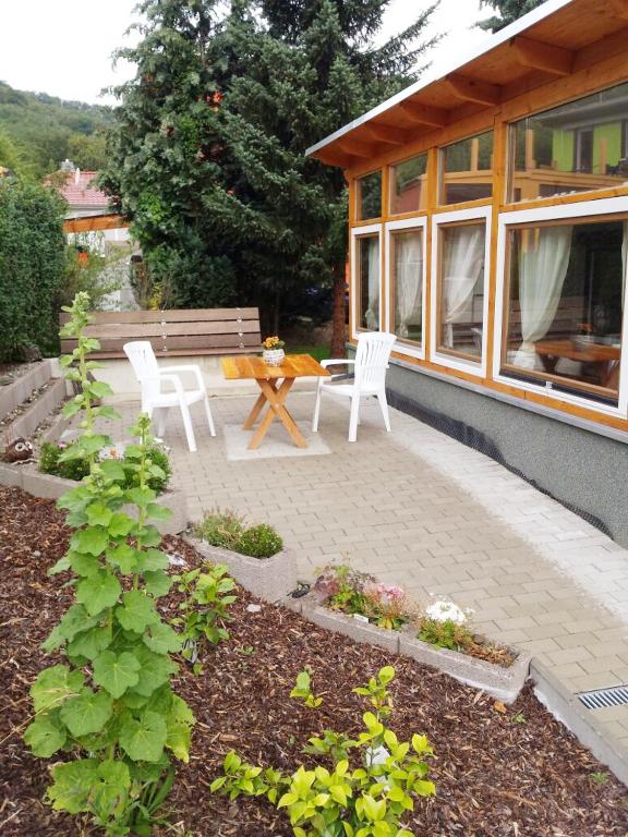a patio with two chairs and a table and a bench at Ferienhaus Bielenski in Blankenburg