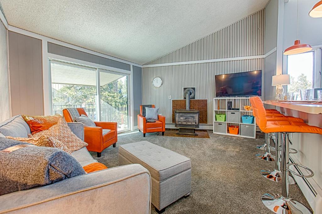a living room with a couch and a tv at Gold Camp Gold Pan Condo: On Shuttle Route in Breckenridge