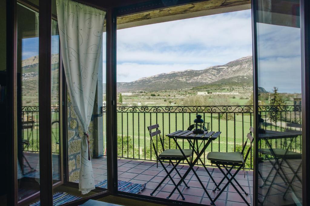 a patio with a table and chairs on a balcony at Apartaments Espai d'Àger in Àger