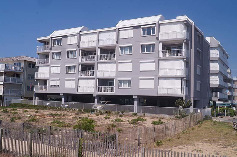 a large apartment building with a fence in front of it at Sungate 402 in Ocean City