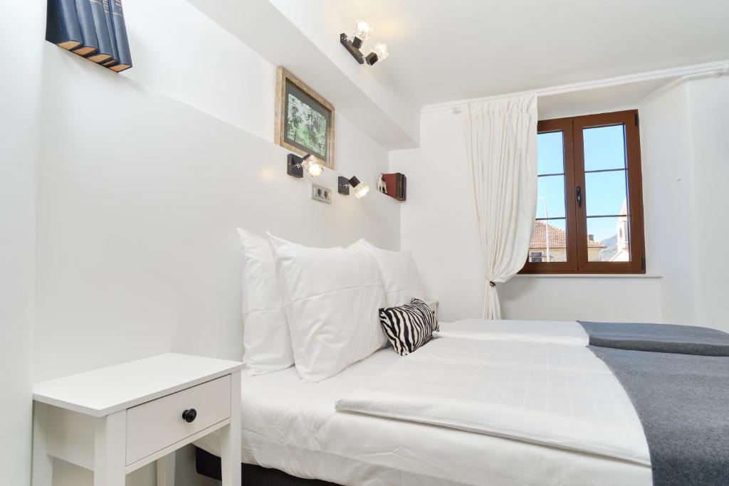 Postel nebo postele na pokoji v ubytování Apartments Zebra