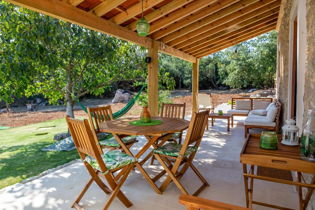 un patio con mesa y sillas bajo una pérgola en Casal das Fontainhas, en Alcobaça