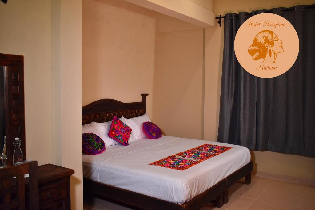 Postel nebo postele na pokoji v ubytování Hotel Peregrina