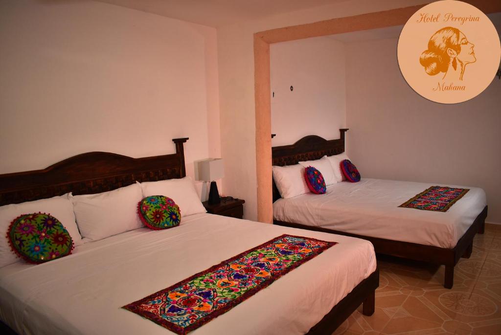 Postel nebo postele na pokoji v ubytování Hotel Peregrina