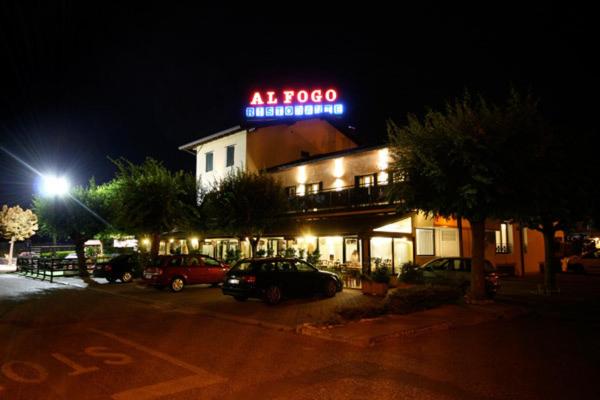 a building with a neon sign on top of it at Hotel Al Fogo in Bevazzana