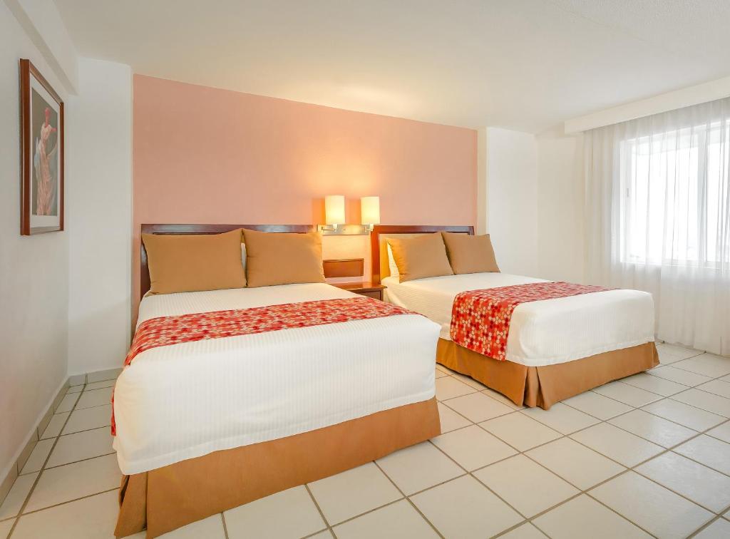 Postel nebo postele na pokoji v ubytování Hotel Veracruz Centro Histórico