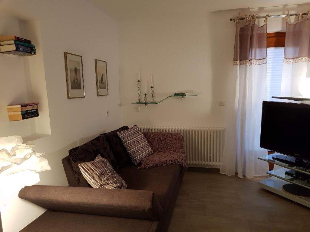 a living room with a couch and a flat screen tv at Ferienwohnungen Vörstetten in Vörstetten