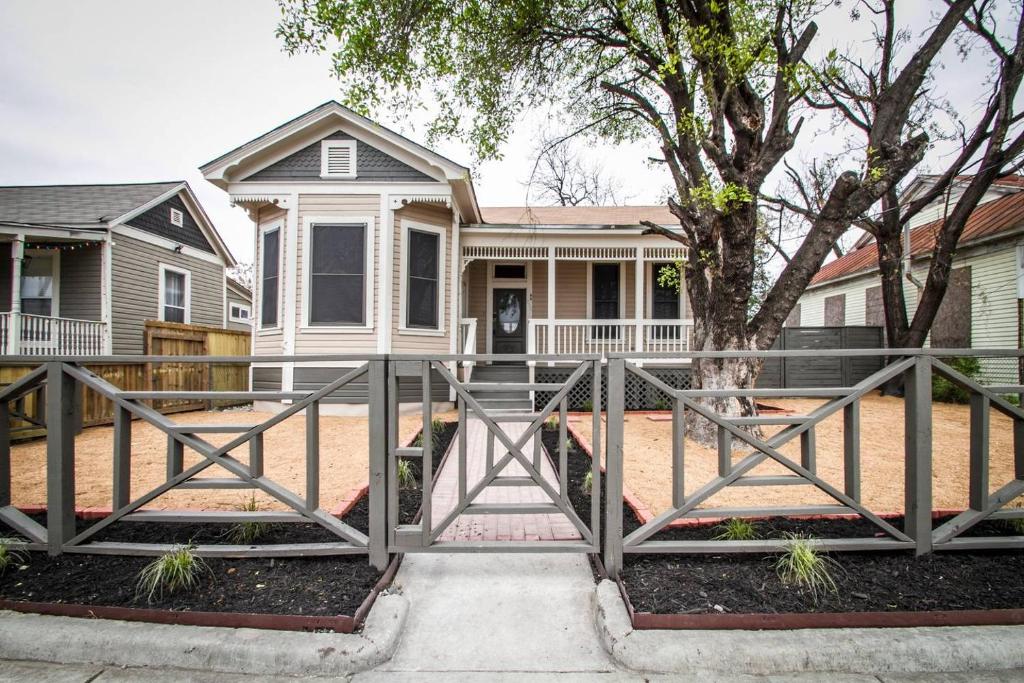 a home with a gate in front of a house at Wyoming St Restored Historic 2BR/1BA Downtown in San Antonio