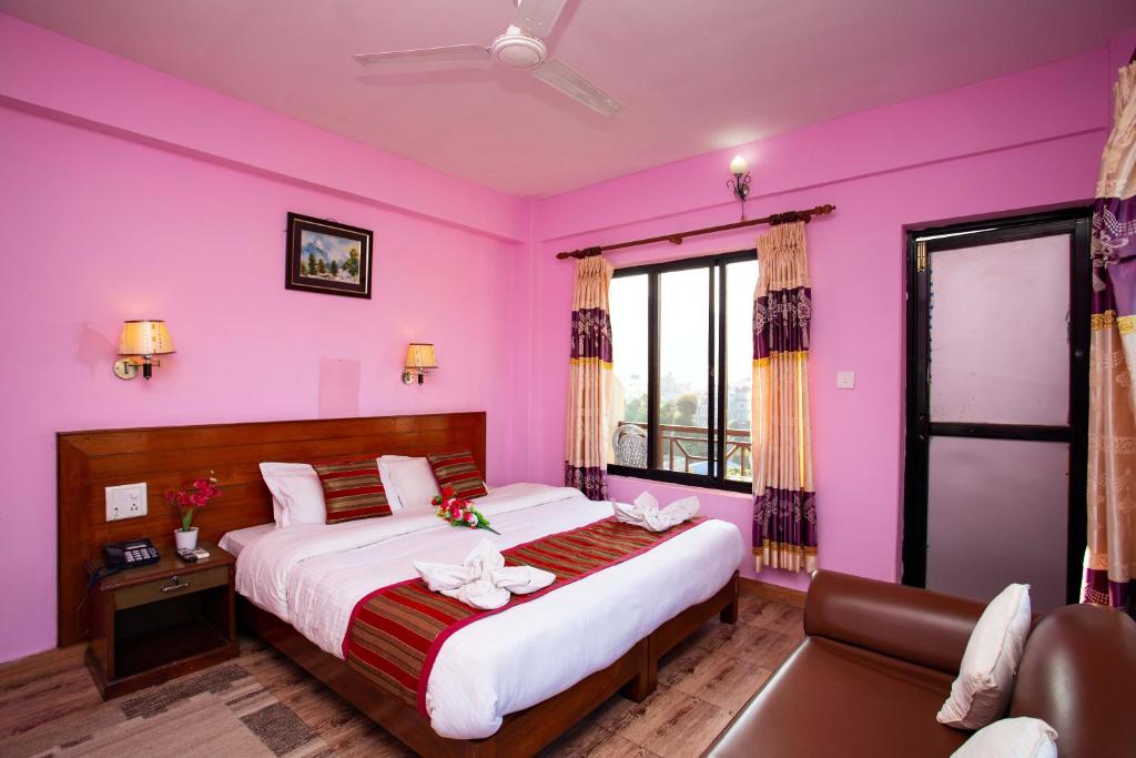 Rúm í herbergi á Hotel Orchid