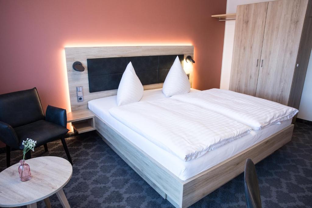 Postel nebo postele na pokoji v ubytování Hotel Wilms