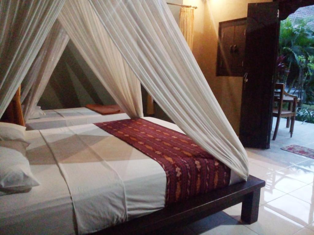 Postel nebo postele na pokoji v ubytování Suka Sari Cottages
