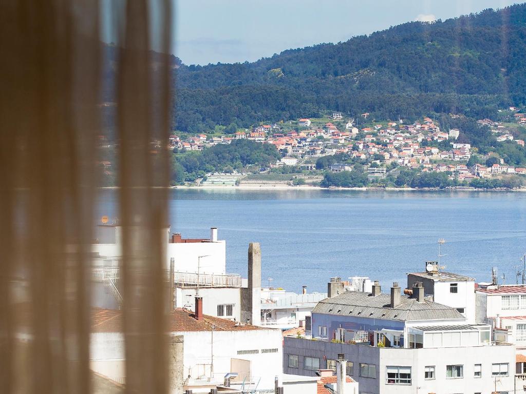 a large building with a view of the water at Oca Ipanema Hotel in Vigo