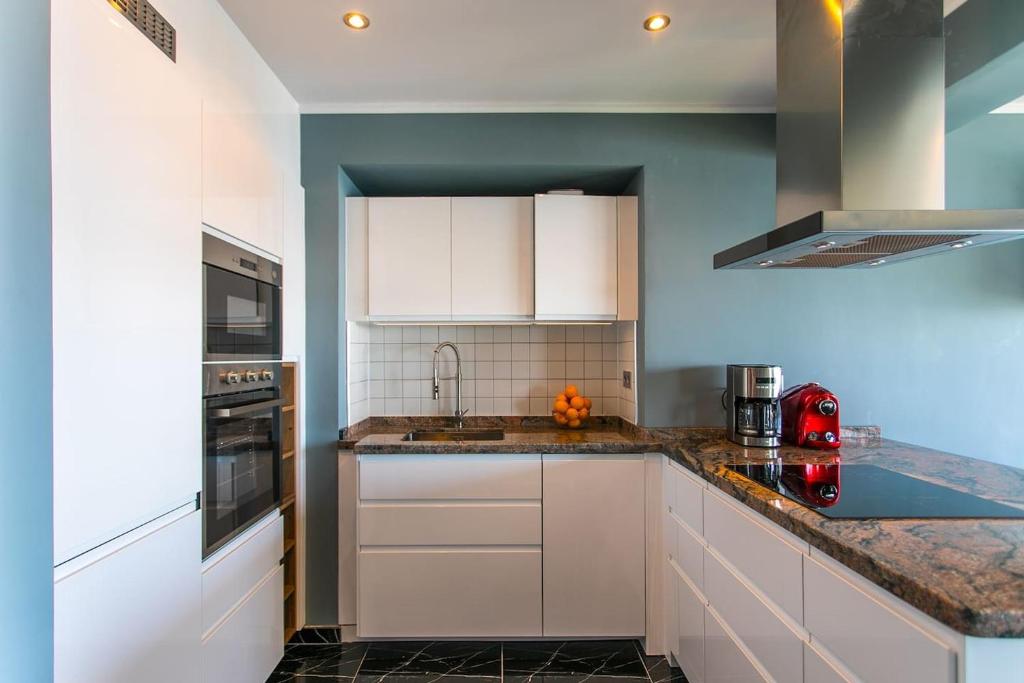 A kitchen or kitchenette at Panoramic Seaview Puerto Marina