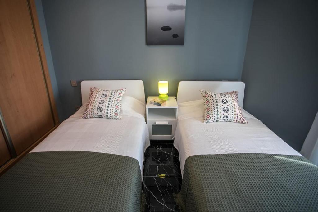 A bed or beds in a room at Panoramic Seaview Puerto Marina