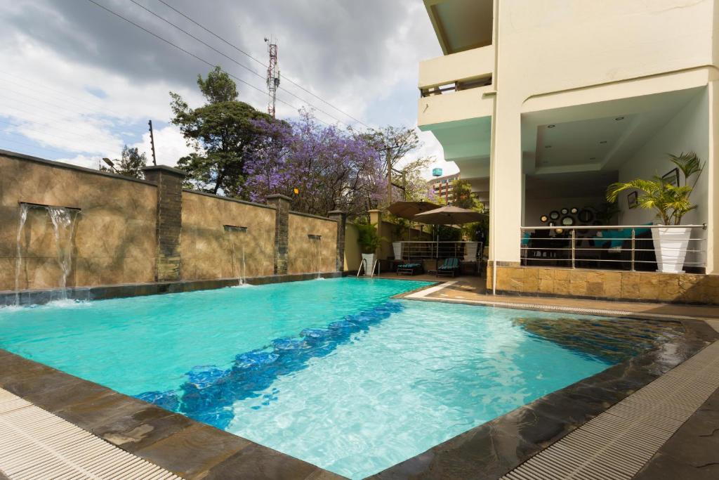 a swimming pool in the middle of a building at Reata Apartment Hotel in Nairobi