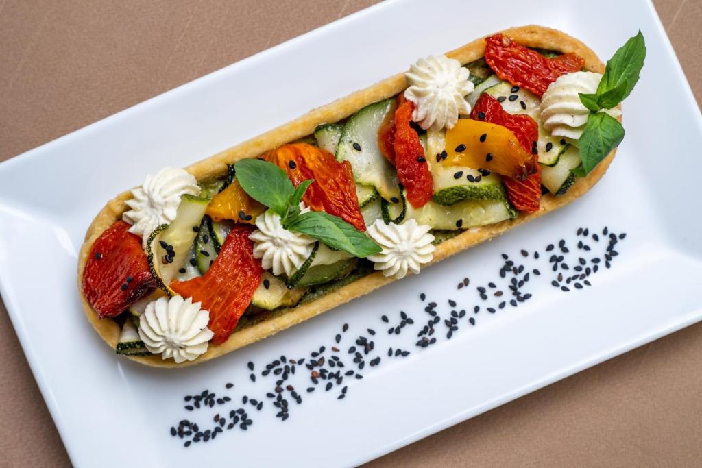 a sandwich on a plate on a white plate at The Aviary Hotel in Siem Reap