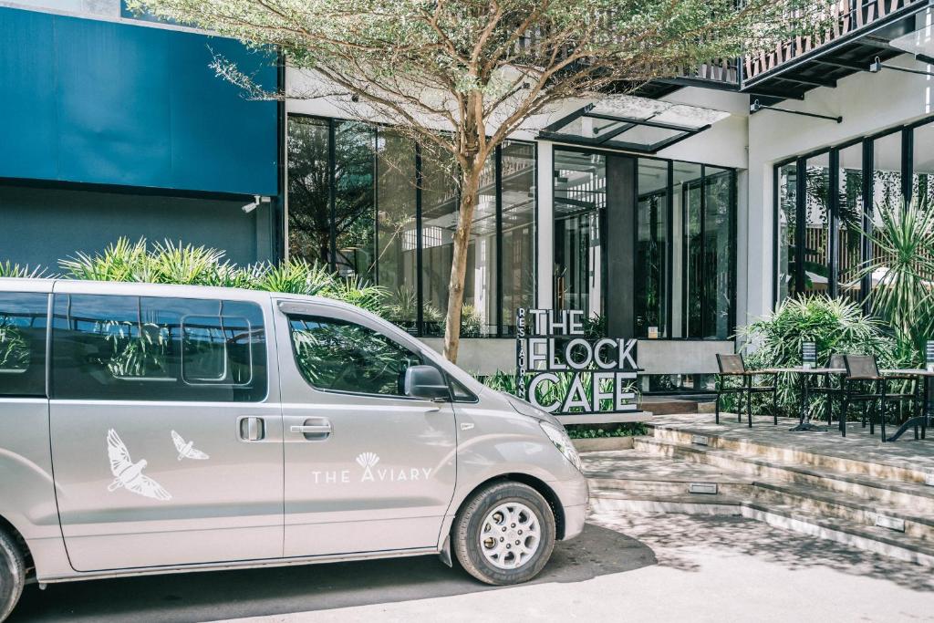 a white van parked in front of a building at The Aviary Hotel in Siem Reap