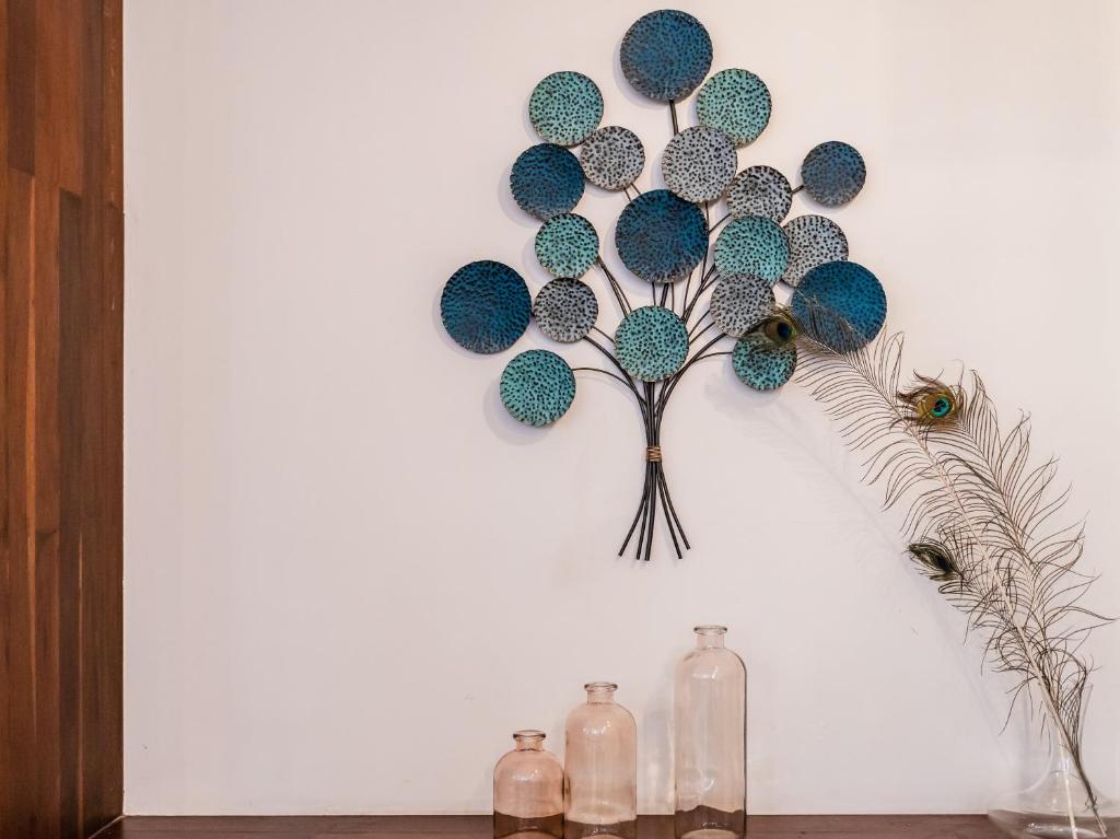 a wall with a decoration of a tree on it at The Aviary Hotel in Siem Reap