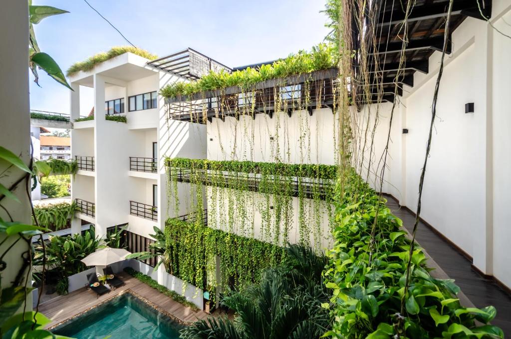 an external view of a building with plants at The Aviary Hotel in Siem Reap
