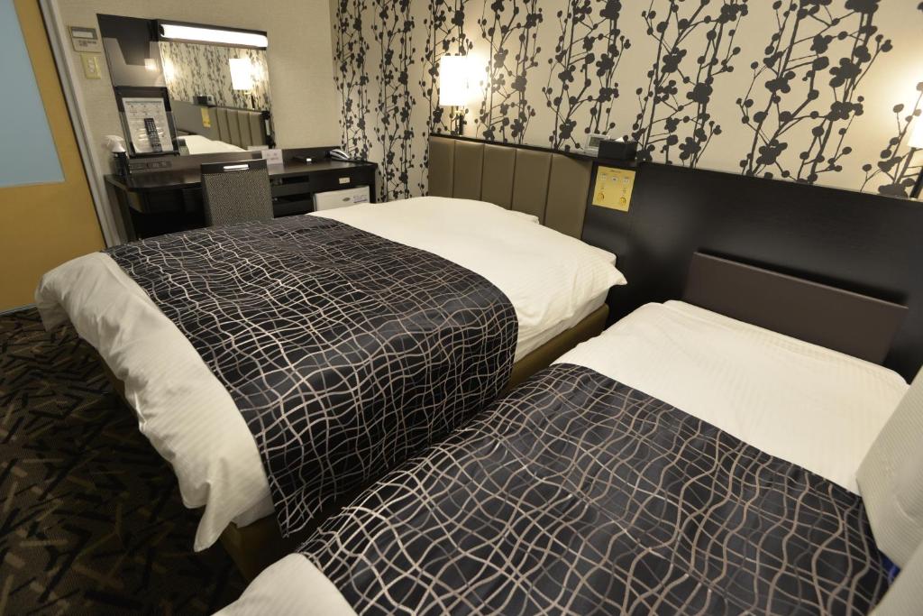 Postel nebo postele na pokoji v ubytování APA Hotel Mie Kameyama