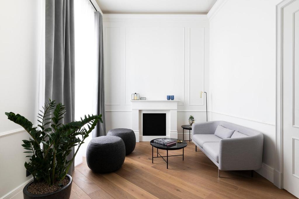 a living room with a couch and a fireplace at Maldà Singular Hotel in Barcelona