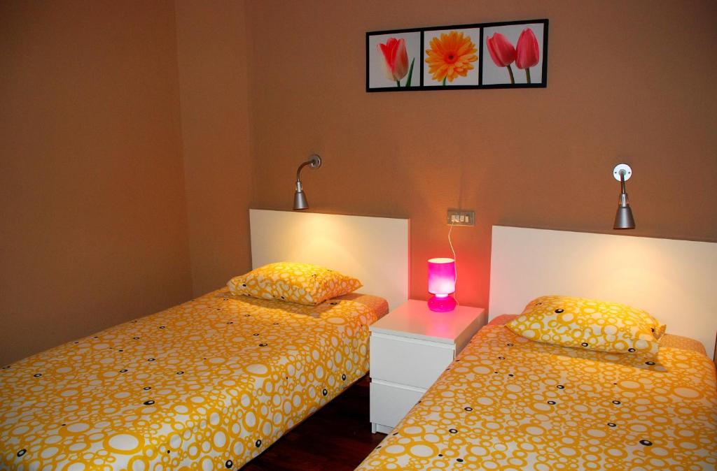 A bed or beds in a room at Apartamentos las Dunas