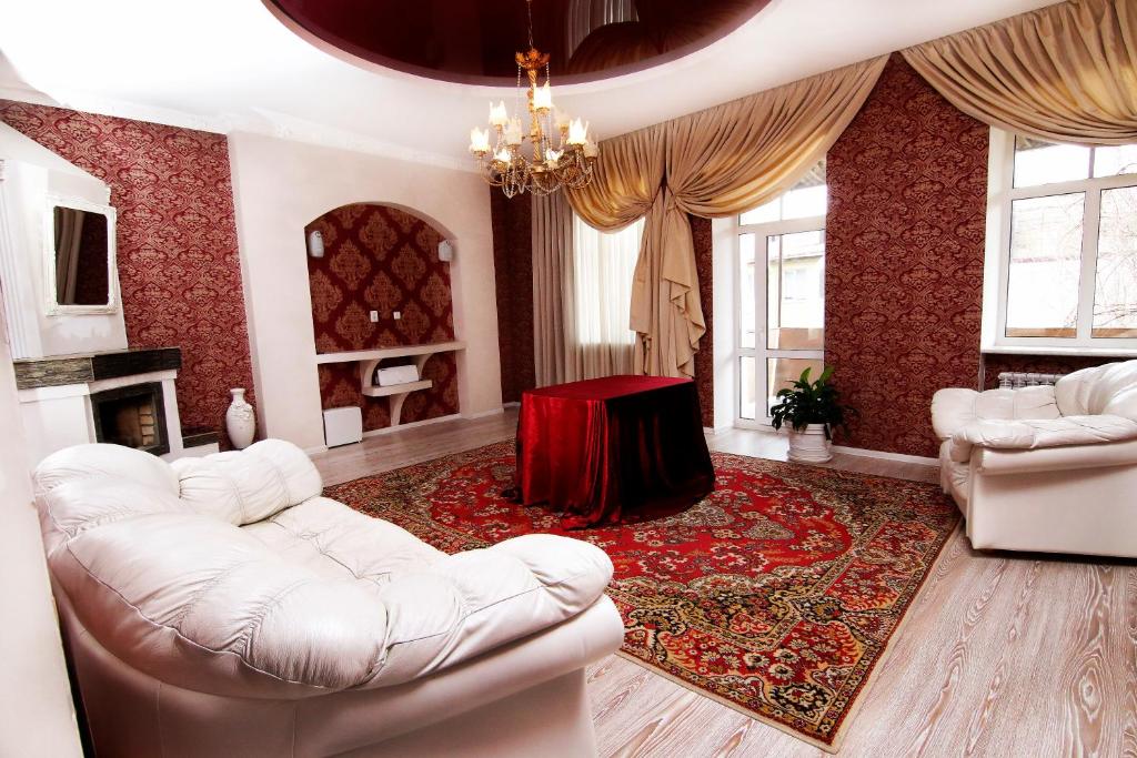 a living room with white furniture and a chandelier at Апартаменты возле Вокзала, Центр in Dnipro