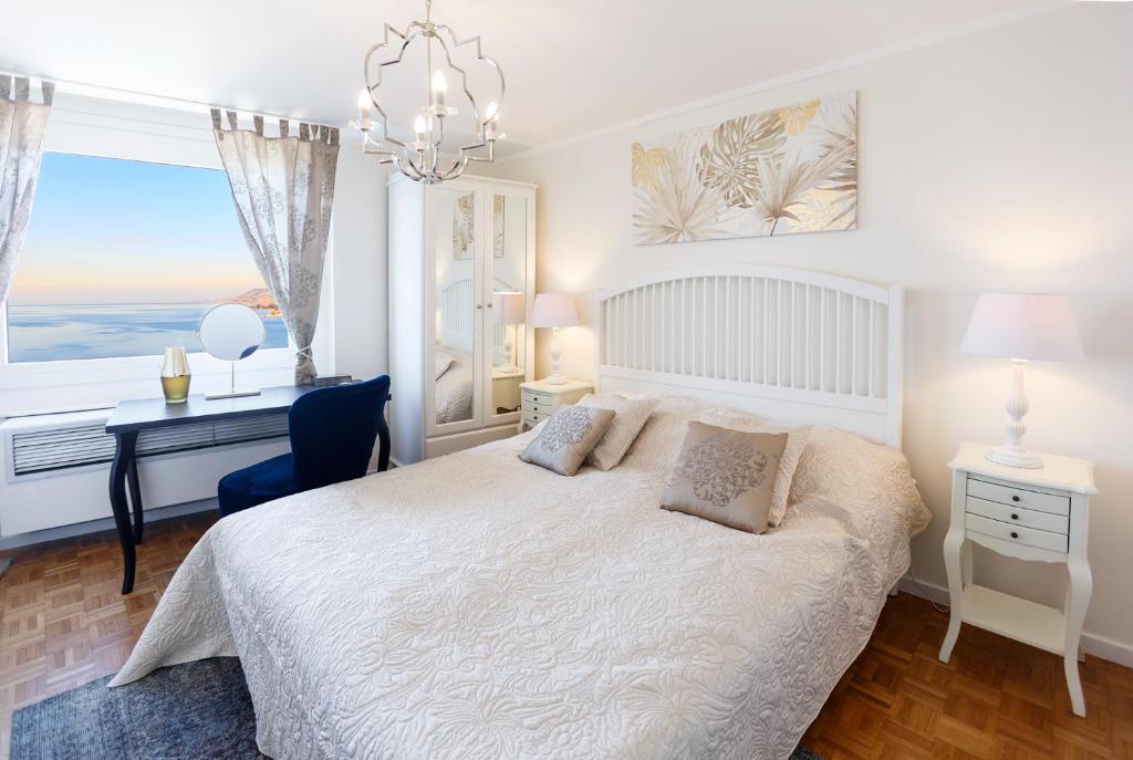una camera da letto con un letto, una scrivania e una finestra di Elegant Apartment with Stunning Lake View a Montreux