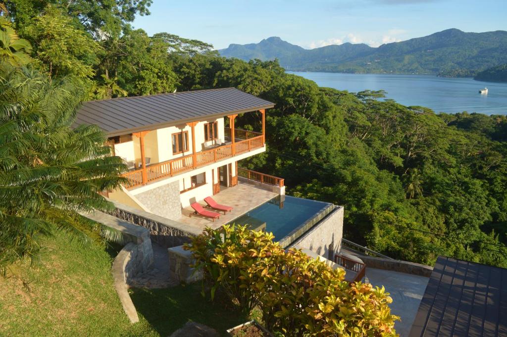 a house on a hill with a view of a lake at La Perle Appartements in Baie Lazare Mahé