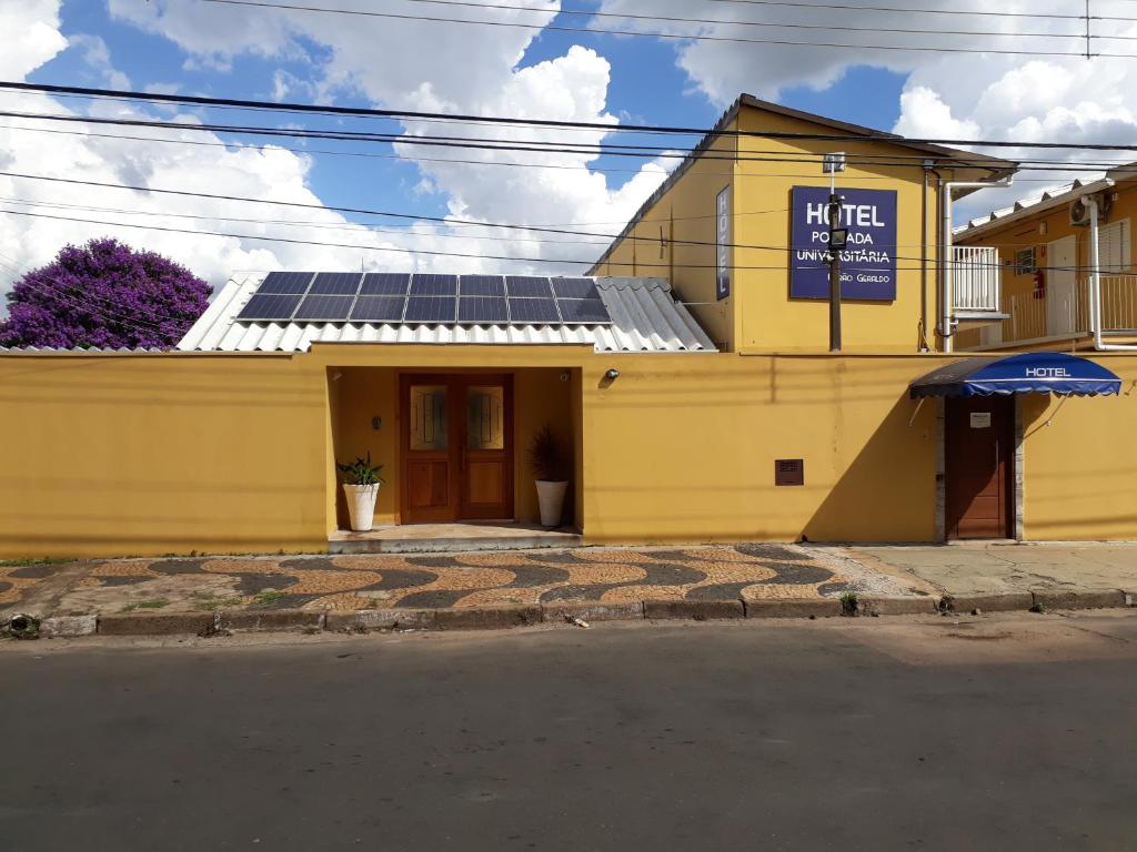 un edificio amarillo con paneles solares en el techo en Unibarão Hotel -Próximo as Universidades Unicamp-Puc-Hospitais -Bancos-Restaurantes-Praça Capital -Shopping Dom Pedro -Ceasa, en Campinas