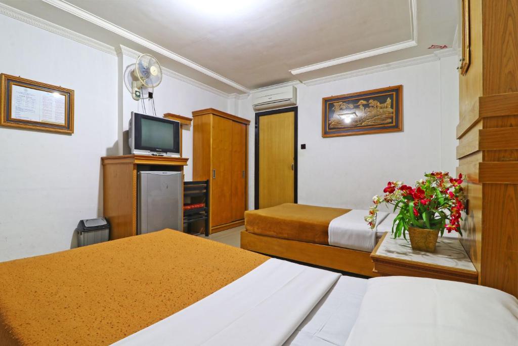 Postel nebo postele na pokoji v ubytování Hotel SAS Syariah