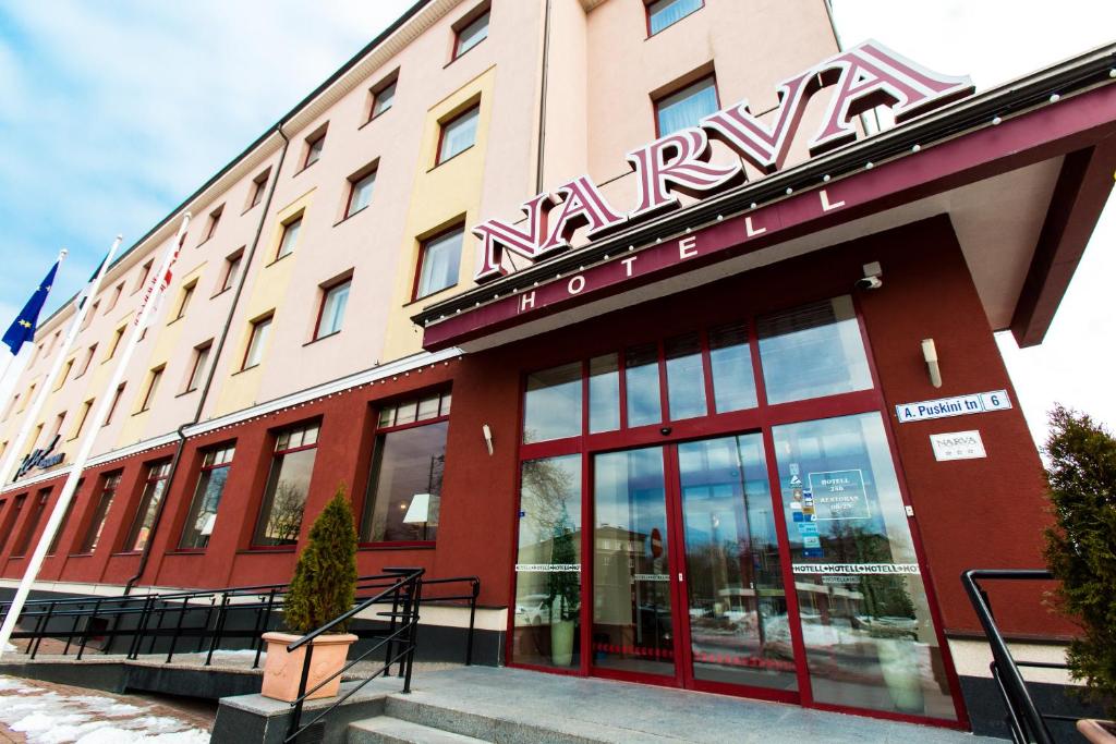 a hotel with a sign on the front of it at Narva Hotell & Spaa in Narva