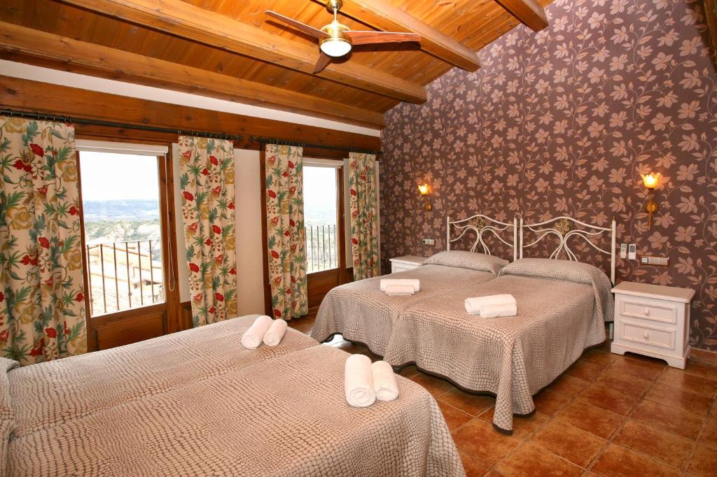 a bedroom with two beds in a room at Casa Avellanas in Alquézar