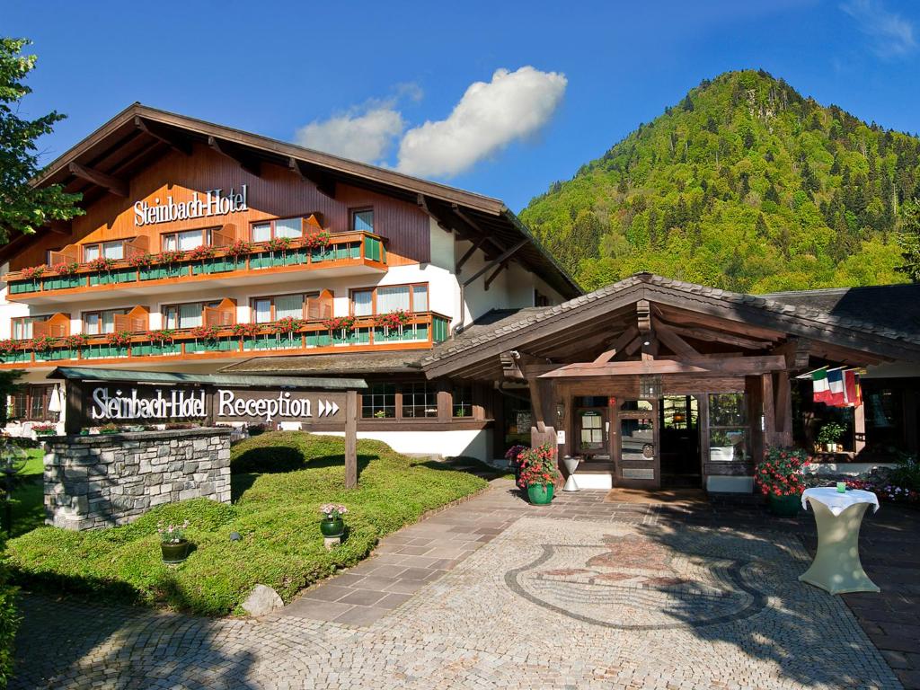 a building with a sign in front of it at Steinbach-Hotel in Ruhpolding