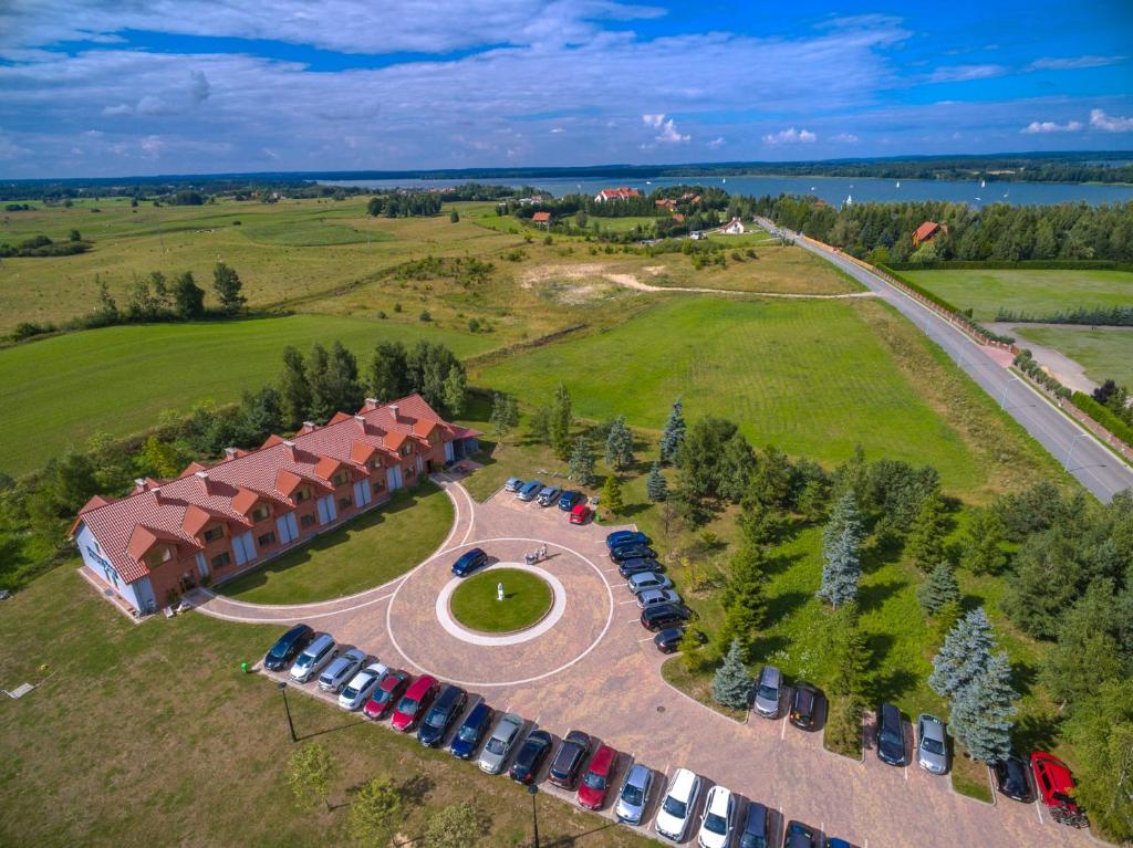 una vista aérea de un edificio con coches aparcados en un aparcamiento en Willa Port en Mikołajki