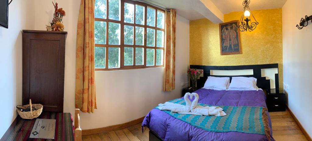 Uma cama ou camas num quarto em Hostal Qolqampata