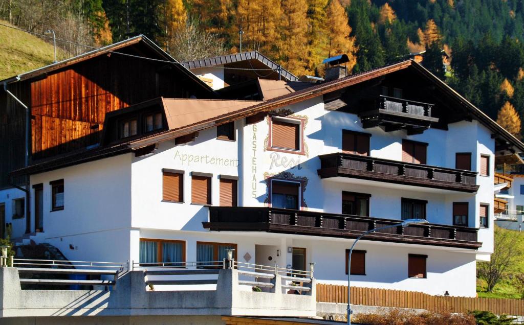 a white building with a brown roof at Gästehaus Resi in Jerzens