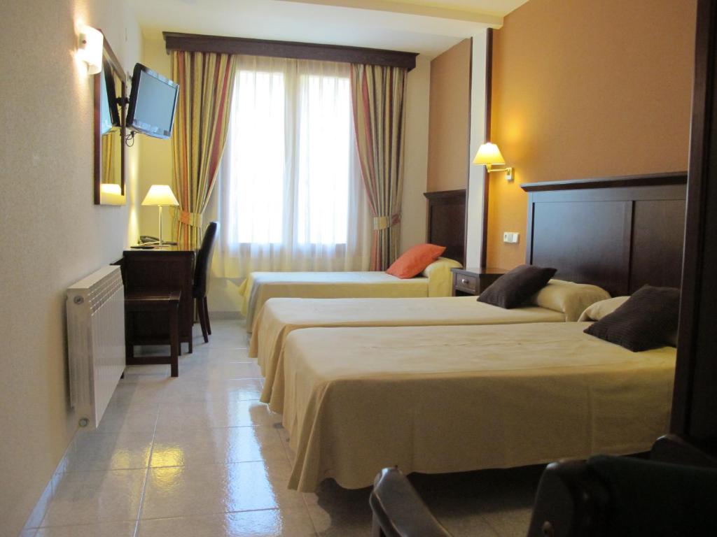Postel nebo postele na pokoji v ubytování Hotel Turmo