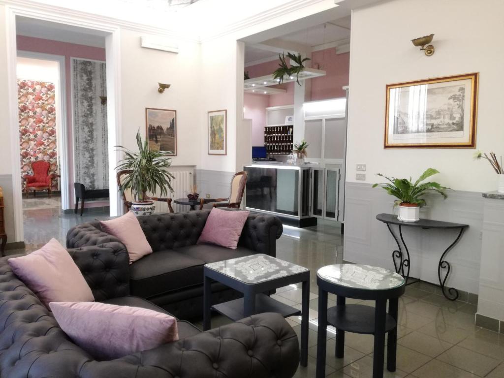 a living room with a couch and tables at Hotel Prati in Montecatini Terme